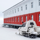 A snowmobile is parked next to a building at the Russian northern military base on Kotelny island.